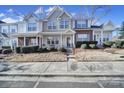 Charming townhome featuring a well-manicured lawn, sidewalk, and covered entryway to welcome you at 1559 Maypine Commons Way, Rock Hill, SC 29732