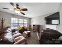 Comfortable living room offers a ceiling fan, a fireplace, and natural light, creating a cozy atmosphere at 1559 Maypine Commons Way, Rock Hill, SC 29732