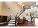 Elegant foyer with staircase, chandelier, rich hardwood floors, and decorative furniture at 16023 Rushwick Dr, Huntersville, NC 28078