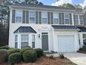 Traditional two-story home featuring a light-colored facade with dark shutters and a one car garage at 1629 Backcreek Ln, Gastonia, NC 28054