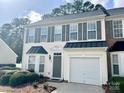 Charming two-story home with a well-manicured lawn and a one car garage at 1629 Backcreek Ln, Gastonia, NC 28054