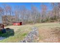 Spacious backyard featuring a rock garden, a shed, and mature trees for privacy at 1740 Young Dr, Conover, NC 28613