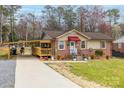 Charming single-story brick home featuring a covered porch, a long driveway, and a well-maintained front yard at 198 33Rd Nw St, Hickory, NC 28601