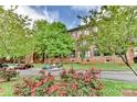 Exterior view of building, street, and colorful landscaping on an overcast day at 201 S Hoskins Rd # 131, Charlotte, NC 28208