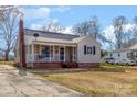 Bungalow-style home with brick accents, front porch with swing, and tidy lawn with space for parking at 201 Wiley Ave, York, SC 29745