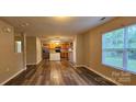 Spacious living room featuring wood-look floors and large windows offering plenty of natural light at 2108 Cranberry Woods Ct, Charlotte, NC 28208