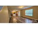 Open-concept living space with wood-look floors, seamlessly connecting the living and dining areas at 2108 Cranberry Woods Ct, Charlotte, NC 28208