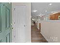 Bright entryway with wood-look floors leading to an open-concept living space at 2592 Brackley Nw Pl, Concord, NC 28027