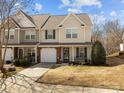 Charming two-story townhouse with a one-car garage, well-maintained lawn, and inviting curb appeal at 2592 Brackley Nw Pl, Concord, NC 28027