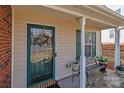 Cozy front porch featuring a wreath, bench, and lush potted plants, creating a welcoming entrance at 2592 Brackley Nw Pl, Concord, NC 28027