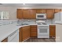 Kitchen with white appliances and modern backsplash at 2592 Brackley Nw Pl, Concord, NC 28027