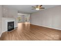 Open living room featuring a fireplace and hardwood flooring at 302 Flanders Dr, Mooresville, NC 28117