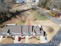 Aerial view of townhomes with well-manicured lawns and mature trees at 304 Valley Brook Se Ln, Concord, NC 28025