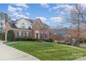 Traditional brick home with manicured lawn, walkway, blue shutters, and a gabled roof on a sunny day at 3101 Colvard Park Way, Charlotte, NC 28269