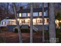 Charming two-story home with a welcoming porch and lush landscaping, nestled among mature trees at 368 Fairfield Ct, Mount Gilead, NC 27306