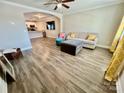 Open-concept living room featuring sleek wood flooring, neutral décor, and abundant natural light at 3726 Windy Pine Nw Ln, Hickory, NC 28601