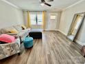 Bright living room with wood floors, comfortable seating, and a view of the front door and window at 3726 Windy Pine Nw Ln, Hickory, NC 28601