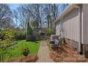 Cozy backyard with brick pathway, garden bed, and bench seating at 420 Medearis Dr, Charlotte, NC 28211