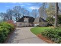 Beautiful home featuring a circular driveway, well-manicured lawn, and lush landscaping at 420 Medearis Dr, Charlotte, NC 28211