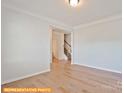 Neutral Living Room that shows off hard wood floors and a natural lit stairwell at 6347 Honor Ave, Midland, NC 28107