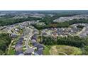 Expansive aerial view of the community and surrounding wooded areas showcase the home's serene location at 7200 Irongate Dr, Lancaster, SC 29720