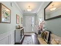 Inviting foyer with light-colored walls, striking artwork, and warm wood floors and stylish furnishings at 7200 Irongate Dr, Lancaster, SC 29720