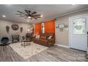 Cozy living room featuring neutral walls, wood-look floors, a ceiling fan, and comfortable seating area at 7271 Hallman Mill Rd, Vale, NC 28168