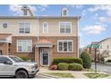 Charming two-story townhome with brick facade, well-maintained landscaping, and copper roof accents at 8410 Scotney Bluff Ave, Charlotte, NC 28273