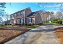 Beautiful home with a long driveway and manicured lawn, showing classic architectural details at 916 Somersby Ln, Matthews, NC 28105