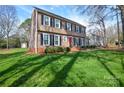 Traditional two-story home with a green lawn and classic black shutters, showcasing a well-maintained exterior at 916 Somersby Ln, Matthews, NC 28105