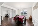 Bright dining room featuring dark hardwood floors, white trim and a large window providing natural light at 9300 Vecchio Dr, Indian Land, SC 29707