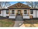 Stunning exterior showcasing the front porch with its unique wooden beams and sleek black accents at 1206 9Th Nw St, Hickory, NC 28601