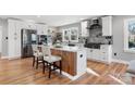 Modern kitchen featuring stainless steel appliances, sleek white cabinetry, and a rustic wood-accented island at 1206 9Th Nw St, Hickory, NC 28601
