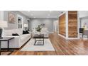 Living room featuring hardwood floors, neutral paint colors, a cozy seating area, and a wood accent wall at 1206 9Th Nw St, Hickory, NC 28601