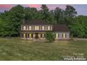 Charming two-story home with a covered porch, surrounded by mature trees at 1226 Flint Ct, Matthews, NC 28104