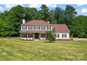 Beautiful two-story home featuring a well-manicured lawn and mature trees at 1226 Flint Ct, Matthews, NC 28104