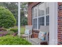 Cozy front porch featuring comfortable seating and vibrant landscaping, perfect for enjoying the outdoors at 12928 Sickles Dr, Charlotte, NC 28273