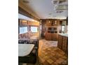 The RV features a dining area and lounge area with plush seating at 131 Twin Bluff Trl # 40, Mount Gilead, NC 27306