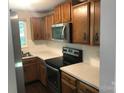 Functional kitchen with stainless steel appliances, wooden cabinetry, and white subway tile backsplash at 1707 Van Dyke Dr, Charlotte, NC 28213