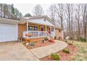 Inviting brick home with a charming, covered front porch featuring white railings and a walkway at 1925 S Lafayette St, Shelby, NC 28152