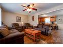 Comfortable living room with hardwood floors, ceiling fan, and view into the adjacent eat-in kitchen at 1925 S Lafayette St, Shelby, NC 28152