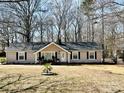 Traditional home boasts a manicured lawn, and a cozy front porch at 1937 Hickory Dr, Lancaster, SC 29720