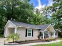 Well-maintained home with a classic ranch-style design, complete with dark shutters, updated siding and mature trees at 1937 Hickory Dr, Lancaster, SC 29720