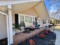 Inviting front porch featuring brick accents and cozy seating at 1937 Hickory Dr, Lancaster, SC 29720