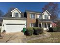 Well-maintained two-story home featuring a spacious two-car garage and a neatly landscaped front yard at 1941 Olsen Ln, Charlotte, NC 28213