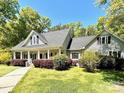 Inviting home featuring a covered porch and lush landscaping enhancing the property's curb appeal at 2025 Sojourn Rd, Marshville, NC 28103