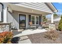 Inviting covered front porch with rocking chairs and stone-wrapped columns at 2211 Waverly St, Albemarle, NC 28001