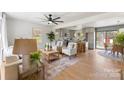 Bright living room featuring hardwood floors and an open concept flowing into the modern kitchen at 2232 Glenraven Ave, Gastonia, NC 28052