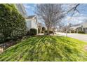 Street view showing lush green lawns, landscaping, and well-maintained homes in a residential neighborhood at 2320 Christensens Ct, Charlotte, NC 28270