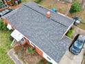 Overhead view highlighting the house's roof, brick exterior, well-maintained landscaping and driveway at 2414 Belfast Dr, Charlotte, NC 28208